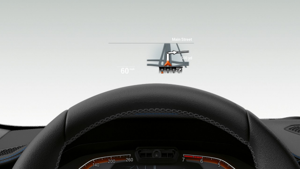 BMW 3 Series Sedan, BMW Head-Up Display. Frontal close-up of half the steering wheel and windscreen of the BMW 3 Series Sedan with BMW Head-Up Display.