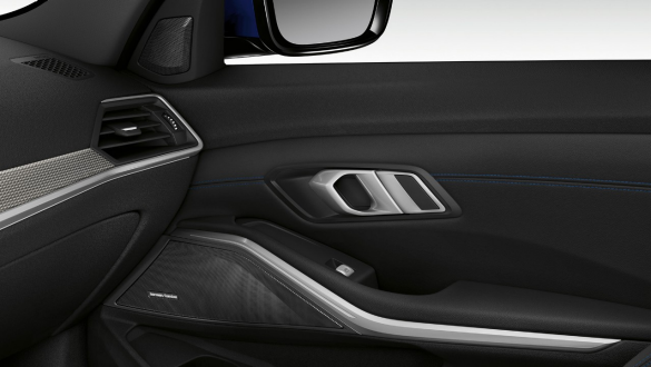 BMW 3 Series Sedan, Harman Kardon surround sound system. Close-up of the inner passenger door illuminated with built-in speaker of the Harman Kardon surround sound system.