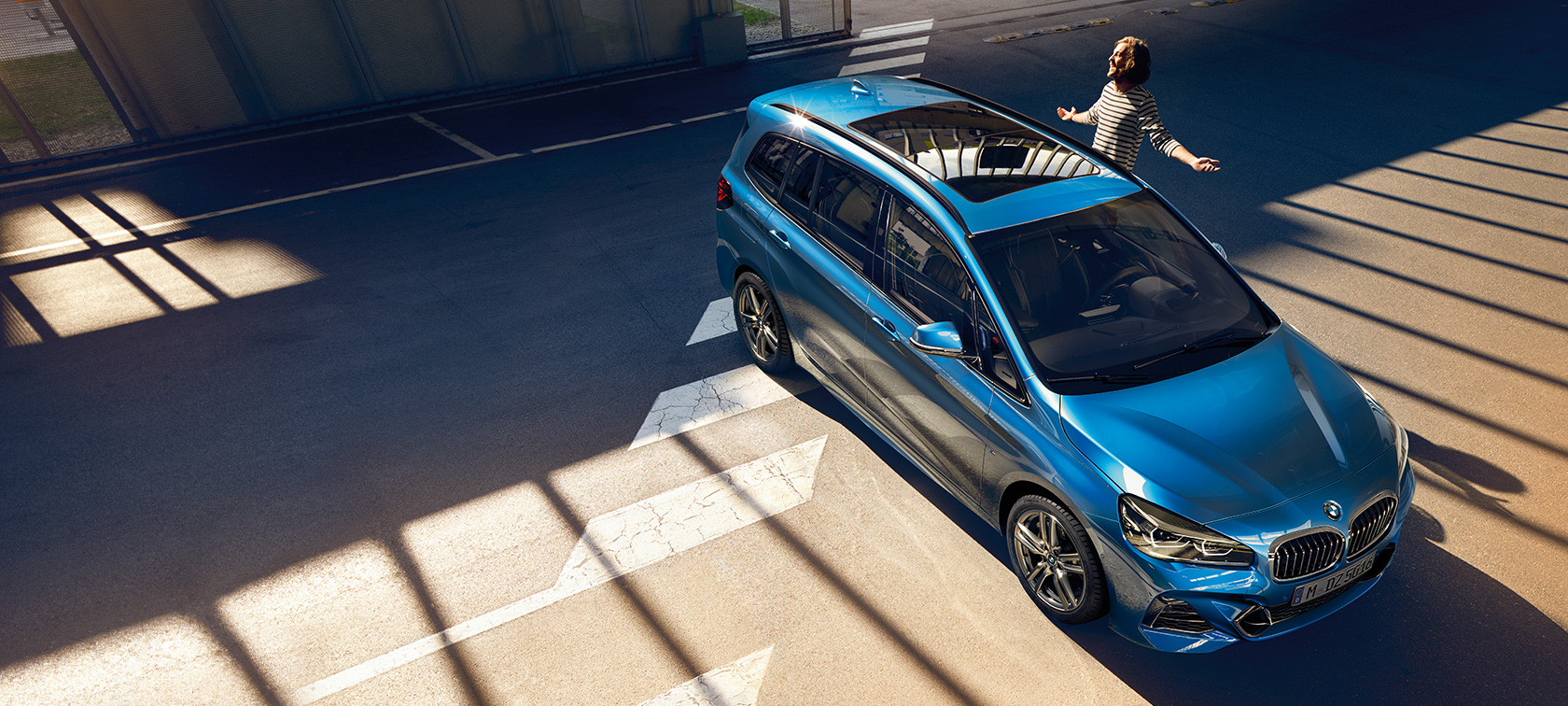 BMW 2 Series Gran Tourer with family Family standing next to BMW 2 Series Gran Tourer F46 2018 Estoril Blue metallic