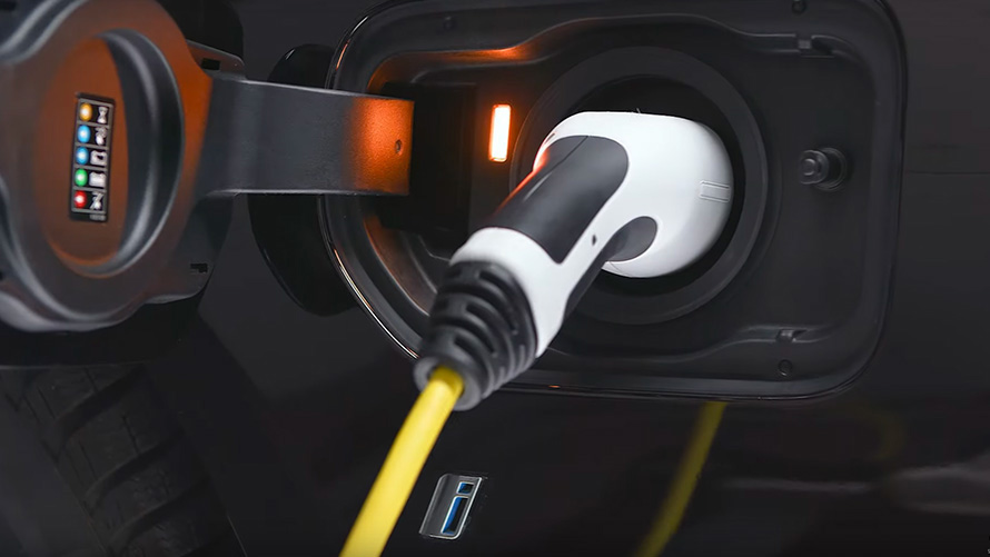 BMW plug-in hybrid connected with charging cable close-up