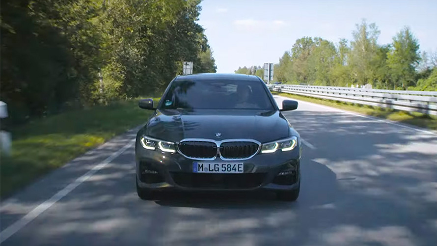 BMW plug-in hybrid driving on the street front view