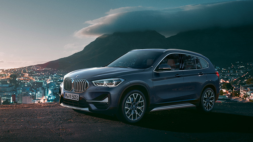 BMW X1 F48 second generation three-quarter side view standing in front of a city BMW X Series BMW X1 F48 second generation three-quarter side view standing in front of a city