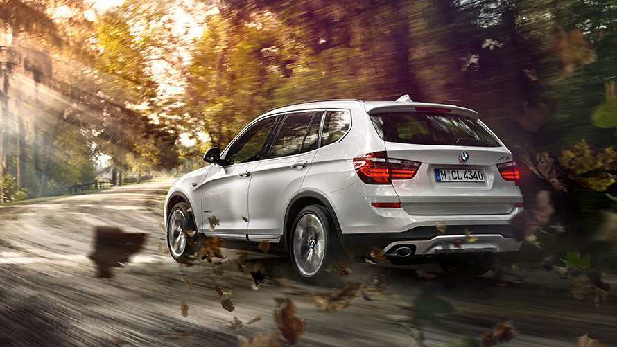 BMW X3 F25 second generation three-quarter rear view driving on the street BMW X Series BMW X3 F25 second generation three-quarter rear view driving on the street