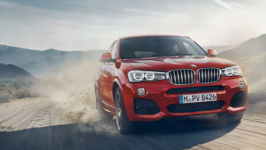 BMW X4 F26 first generation three-quarter front view driving BMW X Series BMW X4 F26 first generation three-quarter front view driving