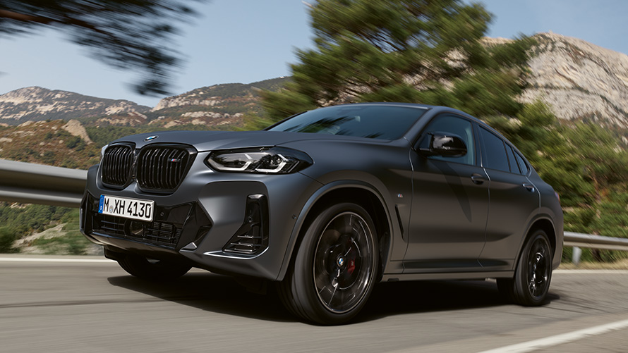 BMW X4 G02 second generation three-quarter side view driving on the street BMW X Series BMW X4 G02 second generation three-quarter side view driving on the street