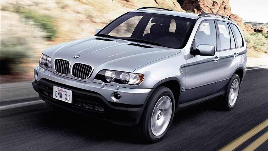 BMW X5 E53 first generation three-quarter front view driving on the street BMW X Series BMW X5 E53 first generation three-quarter front view driving on the street