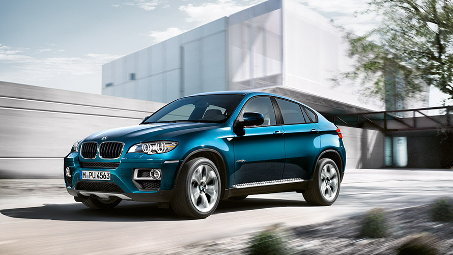 BMW X6 E71 first generation three-quarter side view standing in front of a building BMW X Series BMW X6 E71 first generation three-quarter side view standing in front of a building