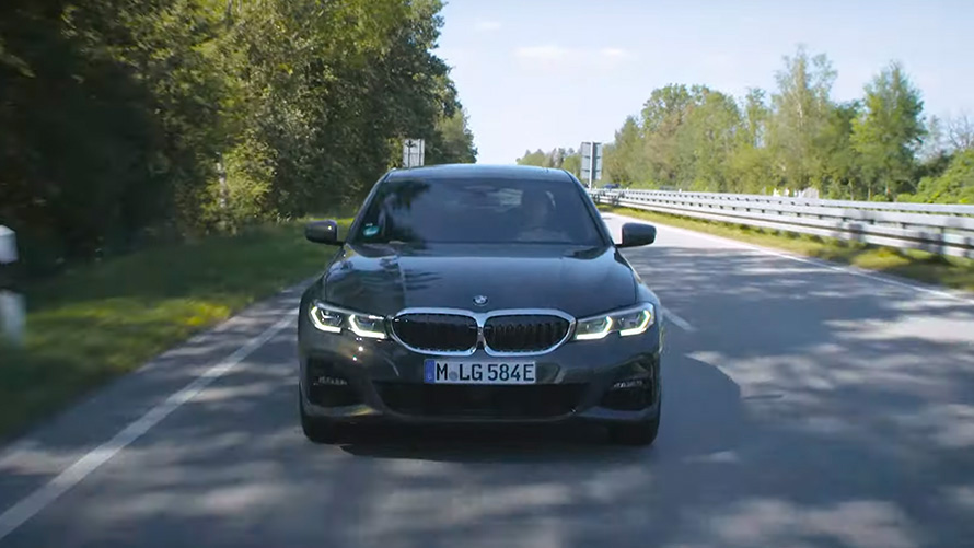 BMW plug-in hybrid driving on the street front view