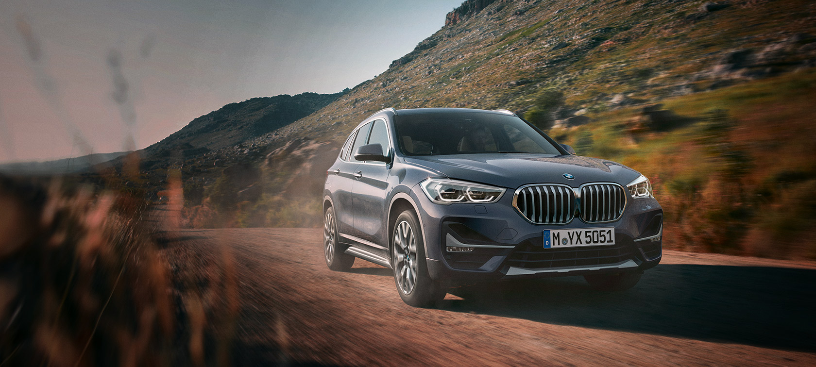 BMW X1 xDrive20i F48 LCI in BMW Individual Storm Baymetallic, driving in winter landscape BMW X1 xDrive20i F48 LCI in BMW Individual Storm Baymetallic, driving in winter landscape