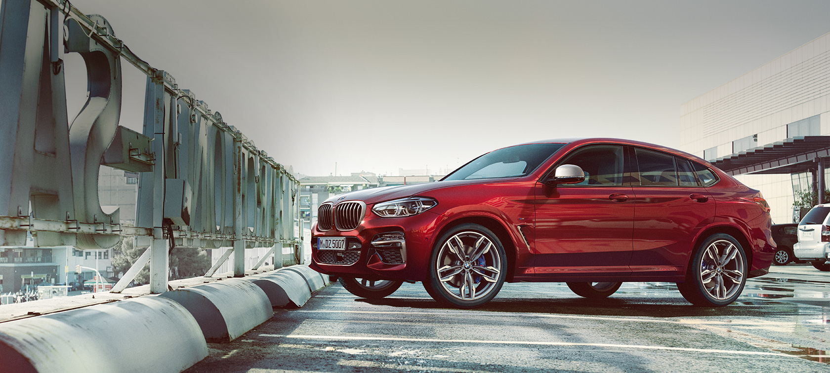 Parking side view BMW X4 BMW X4 M40i G02 2018 Flamenco Red brilliant effect side view parking on parking deck