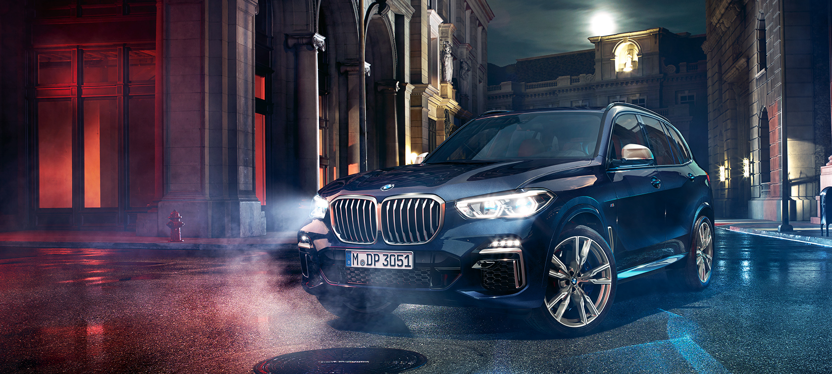 BMW X5 M50d on the road The BMW X5 M50d standing on the road at night against the backdrop of the city