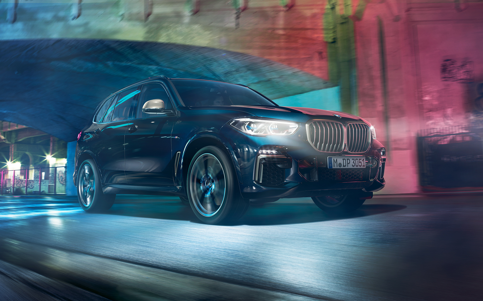 BMW X5 M50d in action Driving shot of the BMW X5 M50d at night in an urban setting