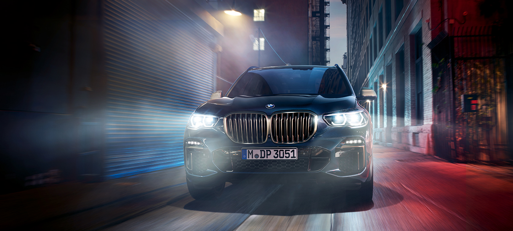 BMW X5 M50d in action The BMW X5 M50d on a street in the city at night