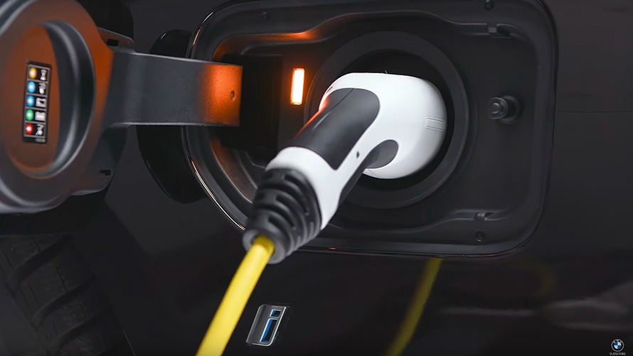 BMW X5 G05 BMW plug-in hybrid connected with charging cable close-up