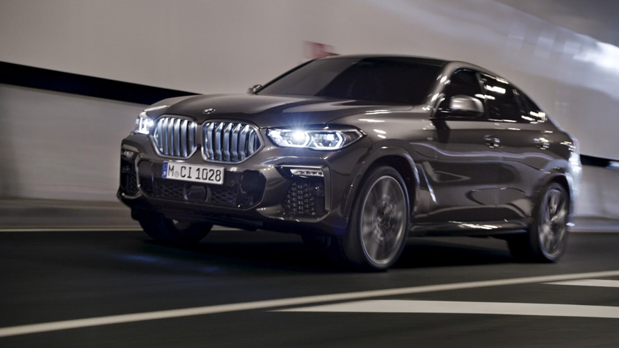 Three-quarter front view BMW X6 G06 2019 BMW X6 G06 2019 three-quarter front view driving in front of an urban setting