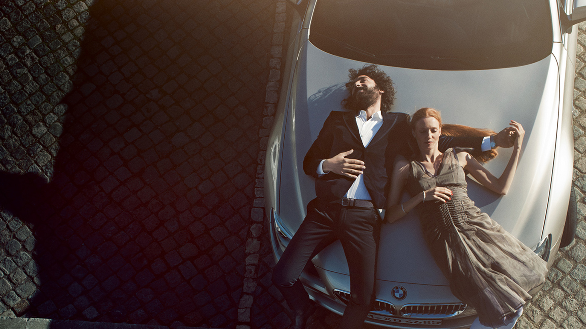 BMW Service Original BMW Engine Oil BMW Service Original BMW Engine Oil man and woman lying relaxed on the BMW bonnet